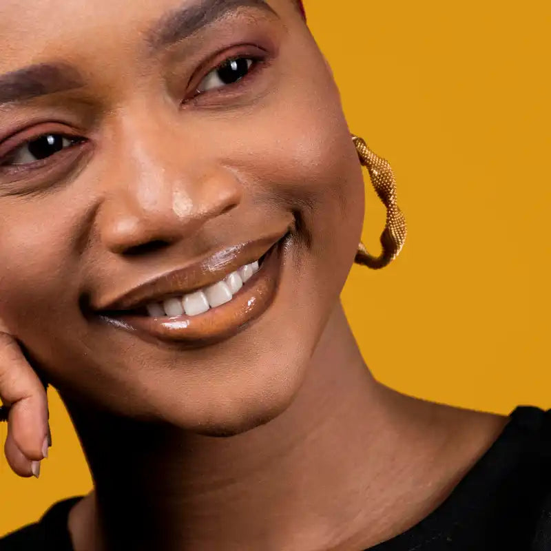 Smiling woman with glossy lips.